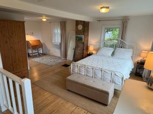 a bedroom with a white bed and a desk at Private duplex on Hudson River in Coxsackie