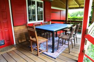 a table and chairs on the porch of a house at Chata Wiedźmy - Sanktuarium Laparica w Puszczy Białej  +39 photos