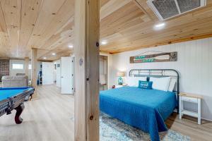a bedroom with a bed and a pool table at Lake Life in Blairsville