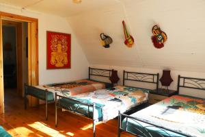 a room with two beds and decorations on the wall at Chata Wiedźmy - Sanktuarium Laparica w Puszczy Białej 