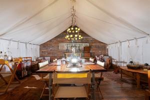 a dining room with a table in a tent at Spacious Bell Tent Retreat-Sleeps Up to 4 Guests in Valle +17 photos
