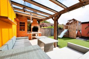 a patio with a table and a playground at Finest Retreats - Elizabeth House in Kington