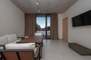 a living room with a couch and a table at 5 Star Apartment in Villa Magnetica in Shekvetili