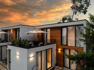 an exterior view of a house with an umbrella at 5 Star Apartment in Villa Magnetica in Shekvetili