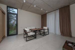 a room with a table and chairs and a large window at 5 Star Apartment in Villa Magnetica in Shekvetili