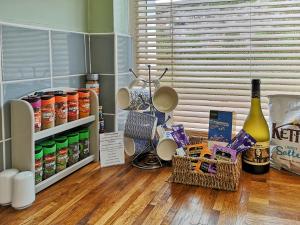 a kitchen counter with a bunch of food and wine bottles at Seascape - St Catherine's Court in Fowey +16 photos