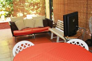 a patio with a couch and a table and chairs at Tortuga Residence in Giardini Naxos