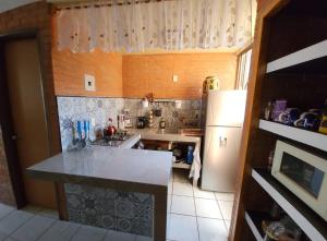 a kitchen with a sink and a refrigerator at Hermosa Casa en Guanajuato Capital in Yerbabuena