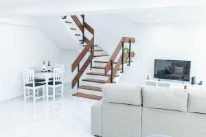 a living room with a couch and a staircase at MCM Matur Flats 2, 11 Duplex in Santa Cruz