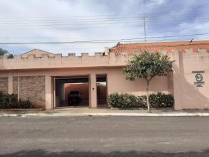 a building with a garage with a car in it at Pousada Am confort turiuba ltda in Turiúba