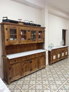 a large wooden cabinet in a room with a floor at Pousada Am confort turiuba ltda in Turiúba