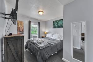a bedroom with a large bed and a window at Babe Ruth Apt 2 All Star Baseball Rentals in Oneonta