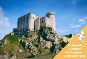 a picture of a castle on top of a mountain at Charme et confort dans le centre-ville de Falaise quartier calme - Larès in Falaise