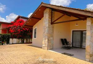 a patio of a house with a roof at Monte das cerejeiras - Bananeiras in Bananeiras