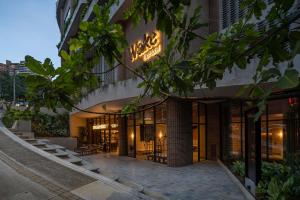 a building with a neon sign on the side of it at Wake BioHotel, a Member of Design Hotels in Medellín
