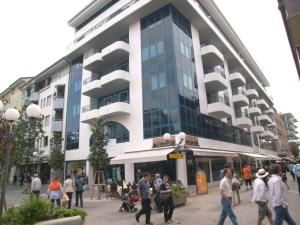 a group of people walking in front of a building at Appartamento La Croma in Grado