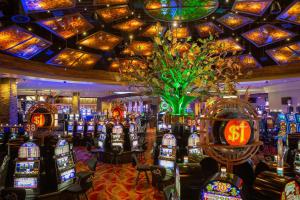 a casino filled with lots of slot machines at The Hotel at Black Oak Casino Resort in Tuolumne