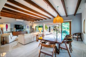 a dining room with a table and a living room at Magnificent Canal House with Dock and Adjacent Golf in Nuevo Nayarit