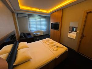 a bedroom with a large bed and a living room at NEAR SUITES in Istanbul