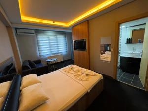 a hotel room with a bed and a living room at NEAR SUITES in Istanbul