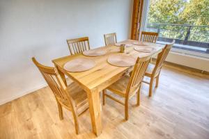a wooden dining room table with chairs and a window at Panorama Nid d'Aigle in Nendaz