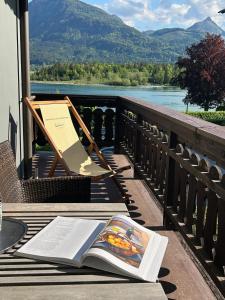 a book sitting on a table with a view of a river at Strandhotel Margaretha in St. Wolfgang +47 photos