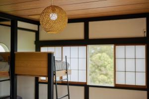 a room with a bunk bed and a chandelier at Omorica Kasumigaura - ペットOK! サウナ BBQ ピザ窯完備 貸切一軒家 - 最大7名宿泊可能 in Tabuse +59 photos