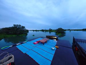 a boat on the water with a table on it at Kbon Homestay Experience in Siem Reap