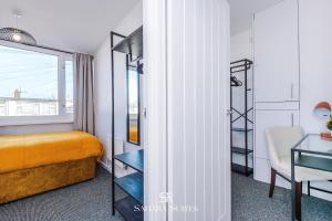 a bedroom with a bed and a table and a chair at Stylish 3BED - Liverpool Centre - Parking - Sleep 5 in Liverpool