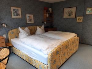 a large bed in a bedroom with a couch at Ferienhaus mit Schwimmhalle in Burgthann +31 photos