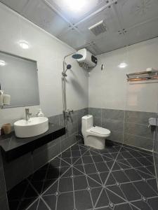 a bathroom with a sink and a toilet and a mirror at Tamcoc Sunseekers Homestay & Hostel in Ninh Binh