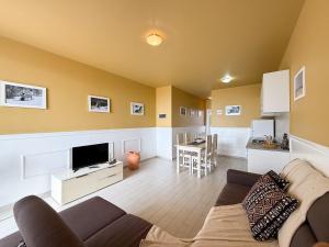 a living room with a couch and a tv at I LOVE BOA VISTA - Seafront Apartments in Sal Rei