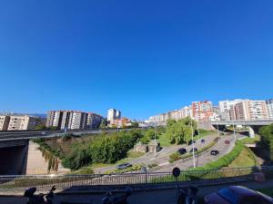 a view of a city with buildings and a highway at 1º IZQ H-1 vistas al mar in Vigo