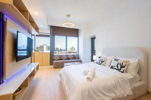 a bedroom with a large bed and a television at Luxury Studio JVC Open View in Dubai +18 photos