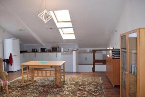 a kitchen with a table in the middle of a room at Downlands Barn apartment 1 Bedroom - 2 Futon in Lounge in Ditchling