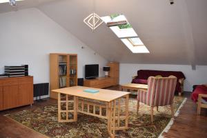 a living room with a table and a couch at Downlands Barn apartment 1 Bedroom - 2 Futon in Lounge in Ditchling