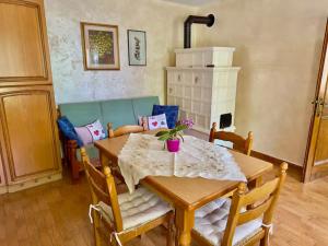 a dining room with a wooden table and chairs at Casa Bagatin in Santo Stefano di Cadore