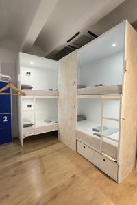a room with white bunk beds in it at Modular Dreams in Madrid +36 photos