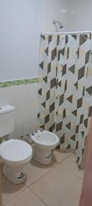 ein Badezimmer mit Toilette und Duschvorhang in der Unterkunft Complejo Los Azahares in Presidencia Roque Sáenz Peña