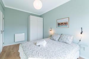 a bedroom with a bed with a white bedspread at Mar e Ria Alvor in Alvor