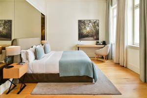 a bedroom with a large bed and a desk at BoHo Prague Hotel - Small Luxury Hotels in Prague +50 photos