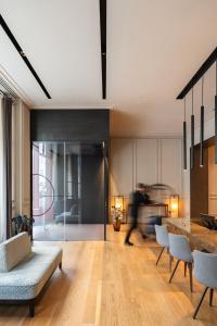 a living room with a table and chairs at BoHo Prague Hotel - Small Luxury Hotels in Prague