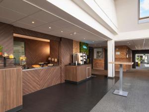a lobby with a counter in a building at Mercure Hotel Zwolle in Zwolle