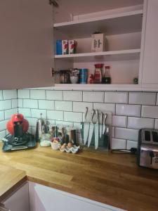 a kitchen counter with utensils on a counter top at Large twin room at Fir Tree Lodge, Shirehampton in Bristol