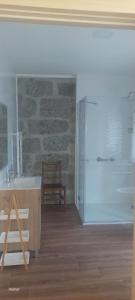 a kitchen with a white refrigerator and a chair at Bosque da Fantasia in Baião +34 photos