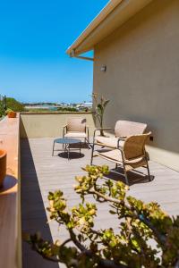 a patio with two chairs and a table on a roof at Azurara Guesthouse in Azurara