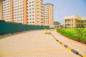 a brick walkway in a city with tall buildings at zenscape oasis in Kisumu