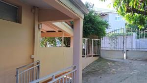 an entrance to a house with a fence and a gate at Appartement confortable à Le Lamentin, 70 m², jardin in Chambort