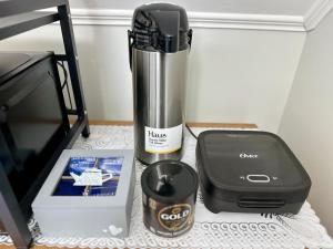 a blender sitting on a counter next to a box at Latitud Stays Puerto Montt in Puerto Montt