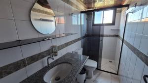 a bathroom with a sink and a toilet and a mirror at Duplex 301C | Alter do Chão in Alter do Chao +7 photos